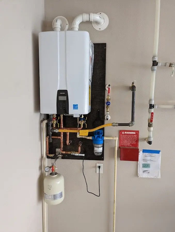 Professional plumber installing copper piping in a Point home
